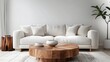 a round wooden coffee table in front of a white sofa in a scandinavian styled living room