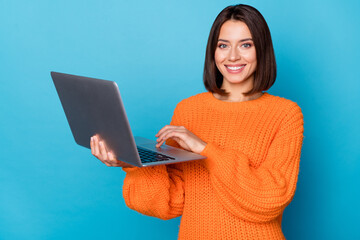 Sticker - Portrait of attractive cheerful skilled girl using laptop creating project isolated over bright blue color background