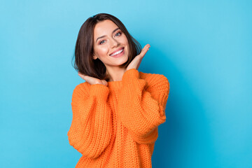 Wall Mural - Portrait of attractive cheerful well-groomed girl touching soft smooth hair isolated over bright blue color background