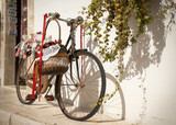 Fototapeta Tęcza - Antique bicycle with basket.. Somewhere on an Italian avenue.
