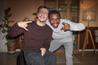 Front view portrait of young man with disability posing with African American friend during house party shot with flash