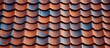 An up-close view of a roof featuring vibrant red and blue tiles in a checkerboard pattern