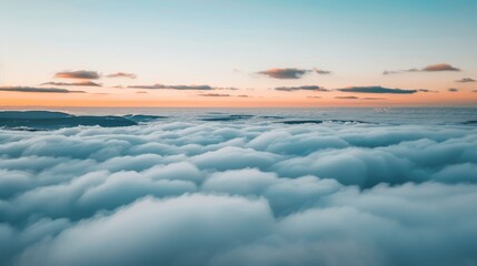 Wall Mural - a view of the sky and clouds from the top of a mountain in the middle of the ocean at sunset.