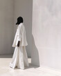 © Adjomassi - Fashion editorial image of a woman wearing a white outfit in a minimalist setting