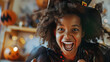 Happy young african american girl dressed as witch at halloween party. Black girl in halloween costume making scary facial expression. Close-up candid portrait of mixed race girl. AI generated