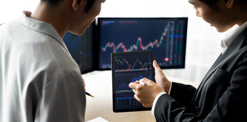 Wall Mural - Cropped image of professional broker show tablet displayed growth graph in skilled trader at stock market. Stock investment. Stock trading. Stock market trading concept. Burgeoning.