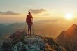 A breathtaking view of a person standing on top of a mountain at sunset. Perfect for outdoor enthusiasts and travel blogs