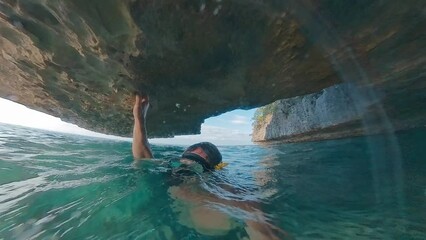 Sticker - Freediver swims underwater in the tropical sea and explores intricate seascape of the West Papua region in Indonesia