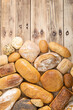 Many kinds and kinds of bread collected in one place on a wooden old shop counter as a decoration for a traditional bakery. View from above.