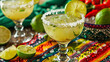 Refreshing Margaritas with Tangy Salsa on Brightly Colored Tablecloth Featuring Vibrant Limes and Spicy Peppers, Perfect for Summer Party, Cinco de Mayo Celebration or Mexican Themed Events 
