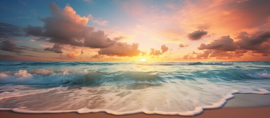 Wall Mural - Sunset over ocean with waves on beach