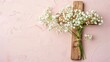 Wooden cross and white flowers on a plain background, banner for Catholic Easter