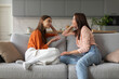 © Home-stock - Loving mother listening to daughter with empathy and understanding, sitting together on sofa at home, parent communicating with teenager
