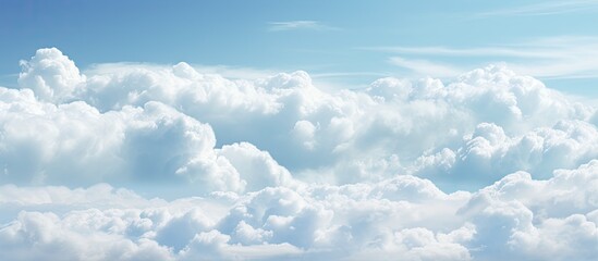 Wall Mural - a landscape with a brilliant electric blue sky filled with fluffy white cumulus clouds, creating a p