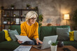 © Miljan Živković - mature caucasian woman use laptop computer at home for work on project