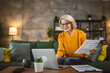 © Miljan Živković - mature caucasian woman use laptop computer at home for work on project