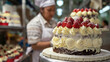 Worker stands with mouthwatering cake amid production.