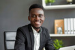 Confident smiling young african businessman looking at camera in office