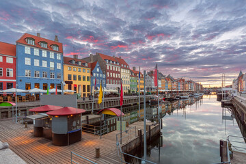 Wall Mural - Nyhavn with colorful facades of old houses and ships in Old Town of Copenhagen, capital of Denmark.