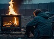 Homeless man sitting by the fire