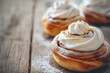 Close-Up Freshly Made Cinnamon Roll With White Frosting On A Wooden Table In Restaurant Interior, Bakery Food Photography, Food Menu Style Photo Image