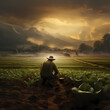 Farmer tending to crops in a rural landscape. 