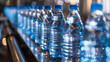 Bottles of water on a conveyor belt. The bottles are blue and clear