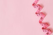 © methaphum - tape measure for obese people on a pink background soft focus