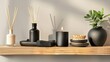 Aromatherapy mockup, black scented candles with aroma reed diffuser on wooden shelf