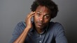 Portrait of a confused puzzled minded black African American man thinking worried expression on empty background
