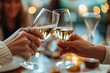 © GodNemesis Art Fanta - Close-up of hands clinking a glass of wine with another unseen individual.