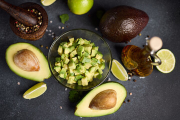 Wall Mural - Chopped avocado in glass bowl and avocado Halves