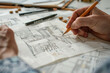 © Emanuel - Interior design sketches. Designer’s hand with a pencil and new kitchen design sketches