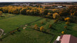 Midwest horse farm with fenced fields and fall leaves