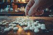 Hand grab white pill from a pile, drug, medicine, health concept