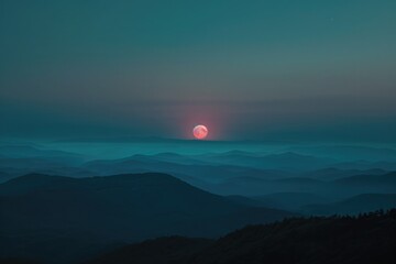 Wall Mural - dramatic mountain moon rise with deep blue night time sky and layered hills in the distance.