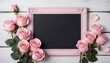 pink painted wooden background with bunch of pink roses and a photo frame black chalk board and white wash wooden flowers for decoration