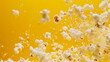 A flurry of popcorn dances against a minimalist yellow canvas.