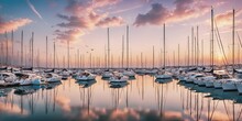Marina At Sunset. A Row Of Sailboats And Motorboats Are Docked At A Calm Marina At Sunset, Casting Long Shadows On The Water.