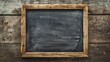 Empty blackboard with wooden frame on old wooden background,