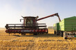 Combine transferring wheat into a trailer after harvest
