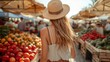 Woman shopping at a bustling farmers market on a sunny day
