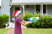 Aussie Boy In Christmas Santa Hat Squirting Water Gun