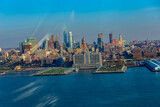 Fototapeta  - New York City skyline and Hudson River as seen from Helicopter at sunset, One World Trade Center view. Aerial view of Manhattan, Battery Park, freedom tower, Downtown, Finance center