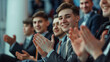 © S photographer - Selective focus of A group of businessmen clapping in a seminar room.