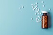 Bottle and scattered pills on color backgroundtop view Space for text