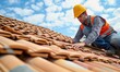 © Filip - Worker with safety yellow helmet working on tiles installation on roof of house