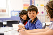© Austockphoto - Boy student smiling in the classroom at a public school