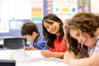 © Austockphoto - Students concentrating writing in the classroom