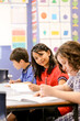 © Austockphoto - Three students sitting at their desk in a school classroom